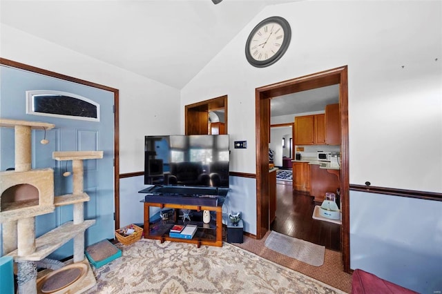 living area with high vaulted ceiling and wood finished floors