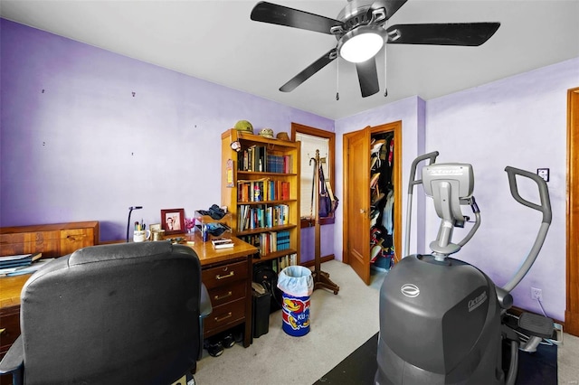 office featuring a ceiling fan and light carpet