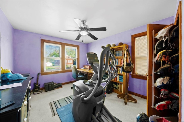 workout room featuring baseboards, ceiling fan, and carpet