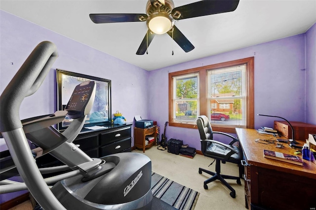 carpeted office space with ceiling fan