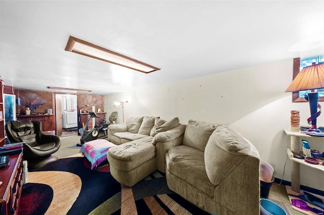 carpeted living area featuring washer / dryer and attic access