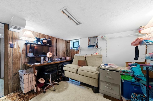 office space featuring a textured ceiling and wooden walls