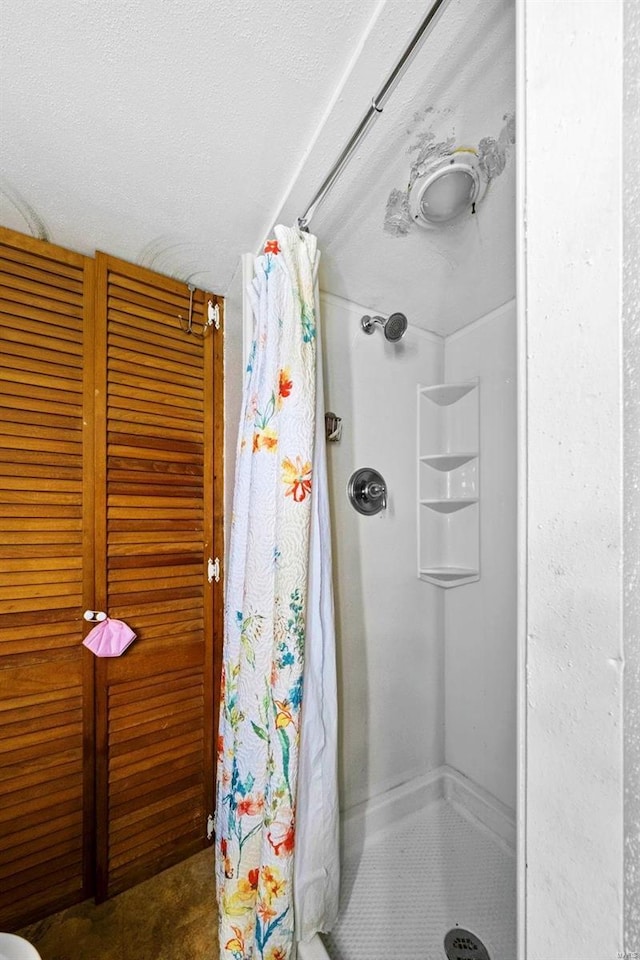 bathroom featuring a shower stall
