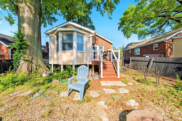 exterior space with a fenced backyard, a deck, and stairway