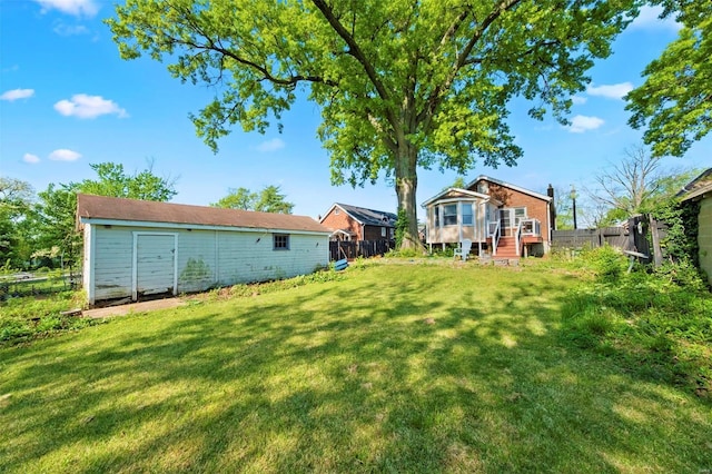 view of yard featuring fence and an outbuilding