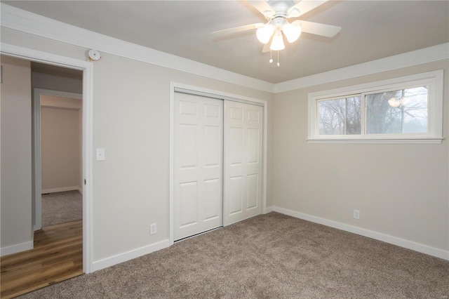 unfurnished bedroom featuring baseboards, carpet, and a closet