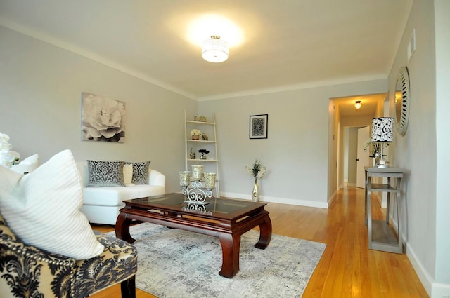 living room with baseboards, light wood-type flooring, and visible vents
