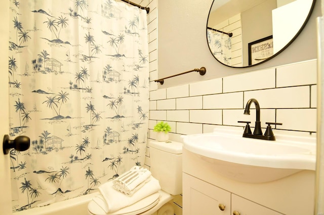 bathroom with vanity, toilet, tile walls, tasteful backsplash, and shower / bath combo