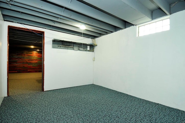 basement with carpet floors and wood walls