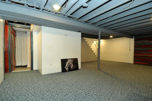 finished basement with stairway and carpet floors