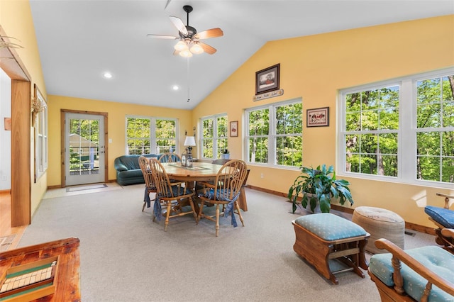 carpeted dining space with a ceiling fan, recessed lighting, baseboards, visible vents, and high vaulted ceiling
