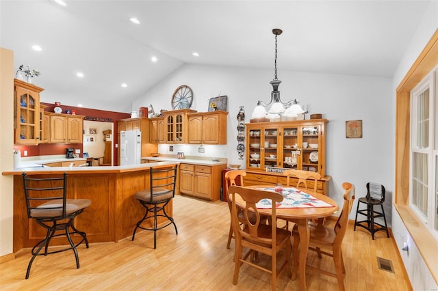 dining room with recessed lighting, visible vents, light wood-style flooring, and high vaulted ceiling