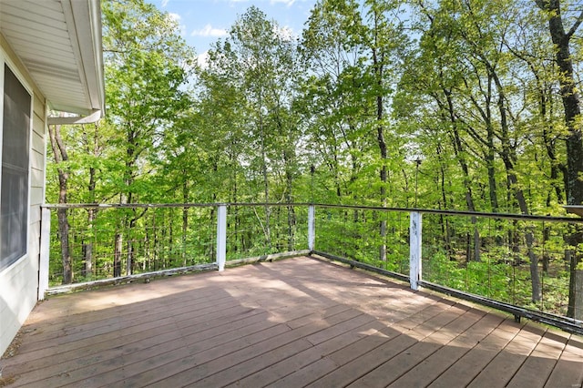 wooden terrace with a wooded view