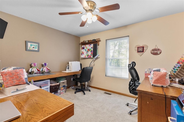 office with carpet flooring, baseboards, and a ceiling fan