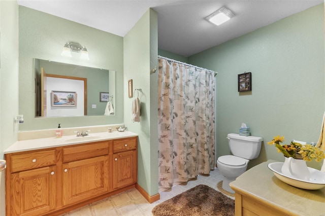 full bath with curtained shower, vanity, and toilet