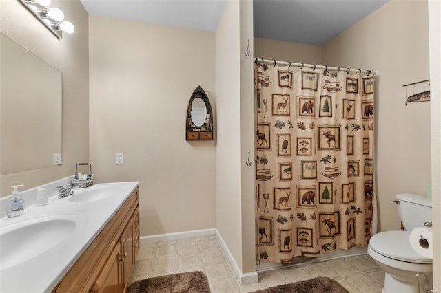 full bath featuring toilet, double vanity, a sink, and curtained shower