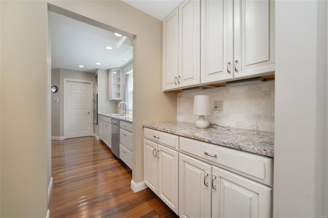 kitchen with dishwasher, dark wood finished floors, recessed lighting, white cabinetry, and decorative backsplash