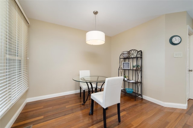 dining room featuring baseboards and wood finished floors