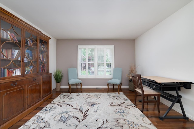 living area featuring baseboards and wood finished floors