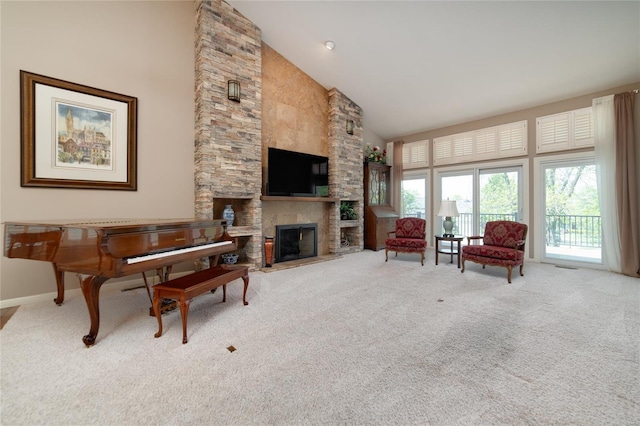 carpeted living room featuring baseboards, a fireplace, a wealth of natural light, and high vaulted ceiling