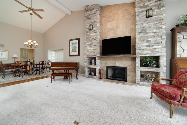 carpeted living room featuring high vaulted ceiling, a stone fireplace, ceiling fan with notable chandelier, beamed ceiling, and visible vents