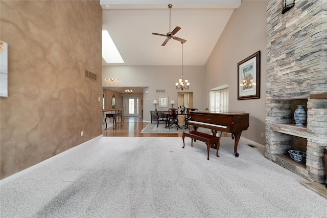 sitting room featuring carpet flooring, high vaulted ceiling, baseboards, and a wealth of natural light