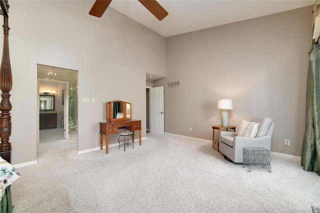 living area with visible vents, carpet flooring, baseboards, high vaulted ceiling, and a ceiling fan