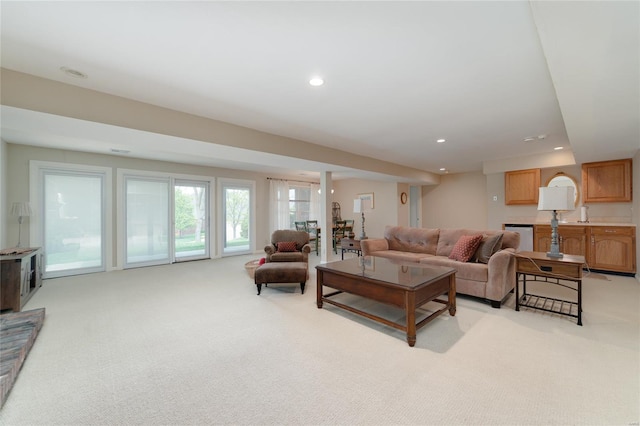 living room featuring recessed lighting and light carpet