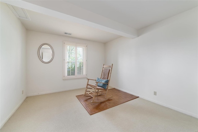 sitting room with baseboards, visible vents, and carpet