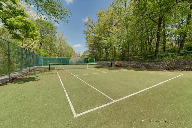 view of tennis court featuring fence