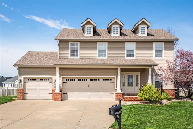 view of front of home with fence, a front lawn, brick siding, a garage, and driveway