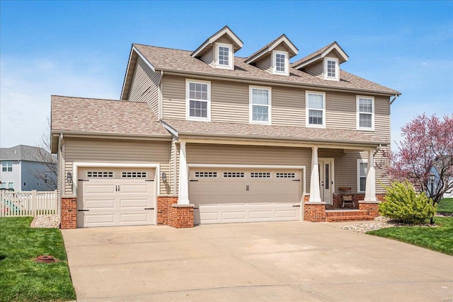 view of front of property with brick siding, fence, and concrete driveway