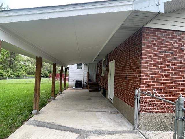 view of patio / terrace with central AC, fence, an attached carport, and entry steps