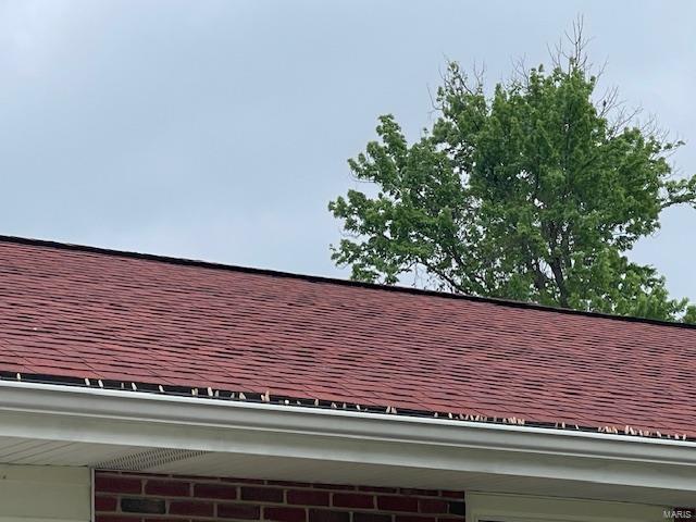 exterior details featuring a shingled roof