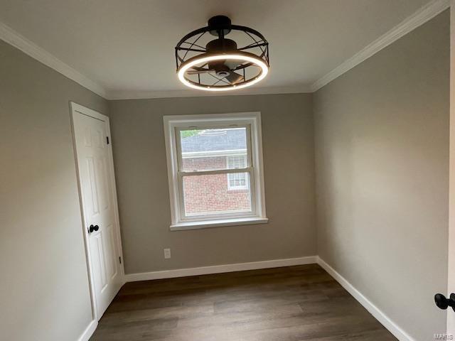 unfurnished dining area featuring baseboards, ornamental molding, and wood finished floors