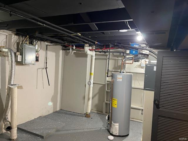 unfinished basement featuring heating unit, water heater, and electric panel