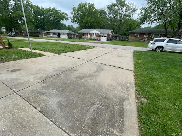 exterior space featuring a residential view and driveway