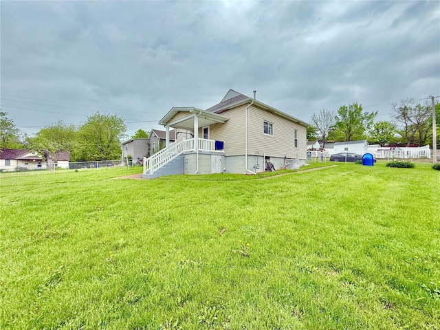 view of property exterior featuring a lawn and fence