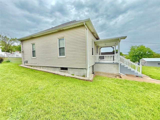 exterior space featuring covered porch and a yard