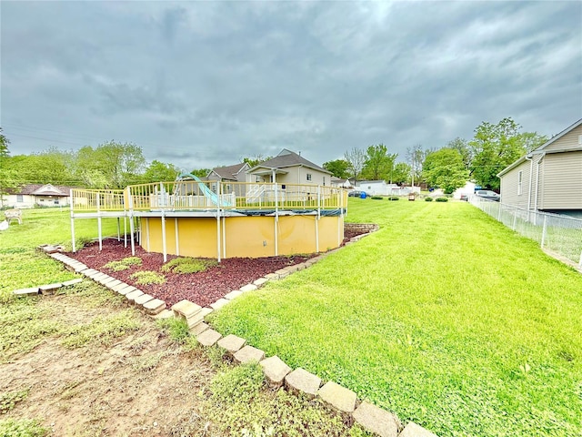 view of yard with fence and a covered pool