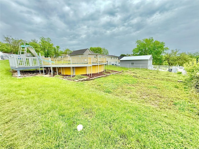 view of yard with fence and a wooden deck