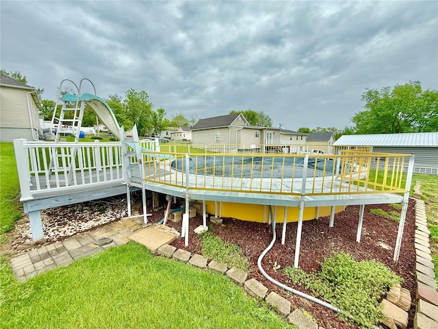 view of yard with a residential view and a wooden deck