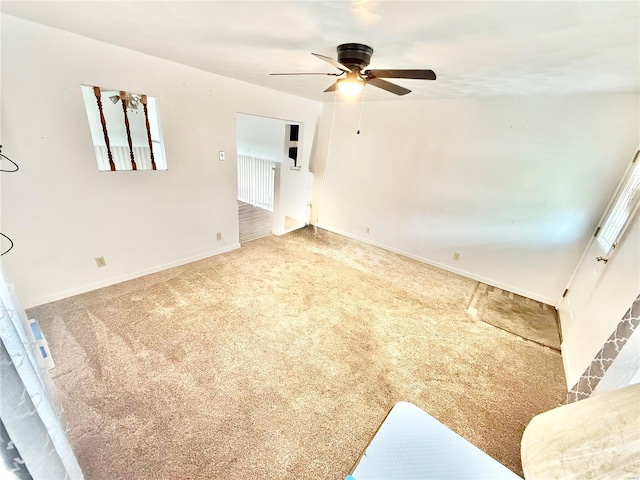 empty room with carpet floors, baseboards, and ceiling fan