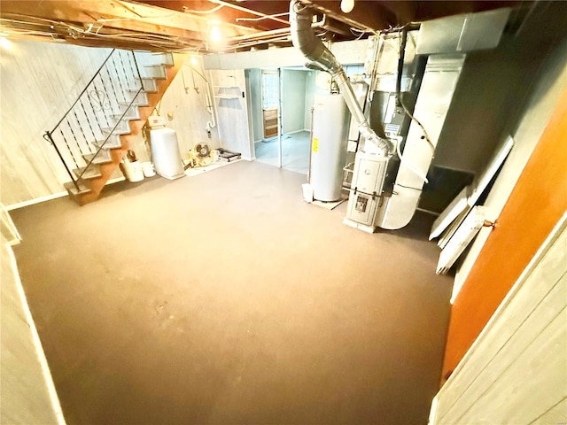 unfinished basement featuring heating unit, gas water heater, and stairs