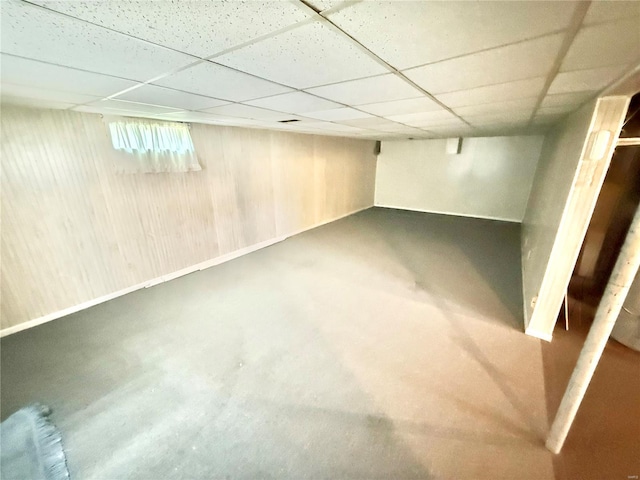 below grade area featuring a paneled ceiling and radiator heating unit