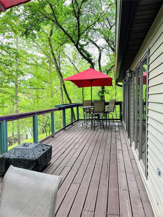 wooden deck featuring outdoor dining space