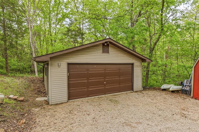 detached garage with a forest view
