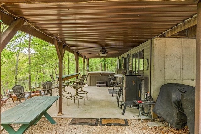 view of patio / terrace with a hot tub, area for grilling, and a ceiling fan