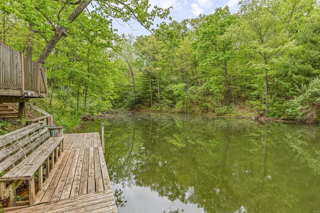 view of dock featuring stairs and a water view
