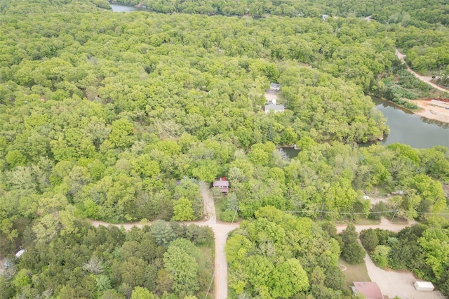 birds eye view of property featuring a water view and a view of trees